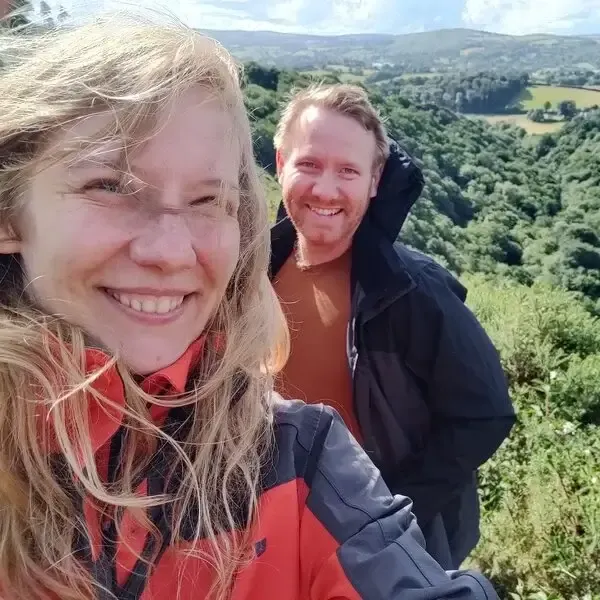 A photo of Nikki on the left and Ozzy on the right, in the countryside.