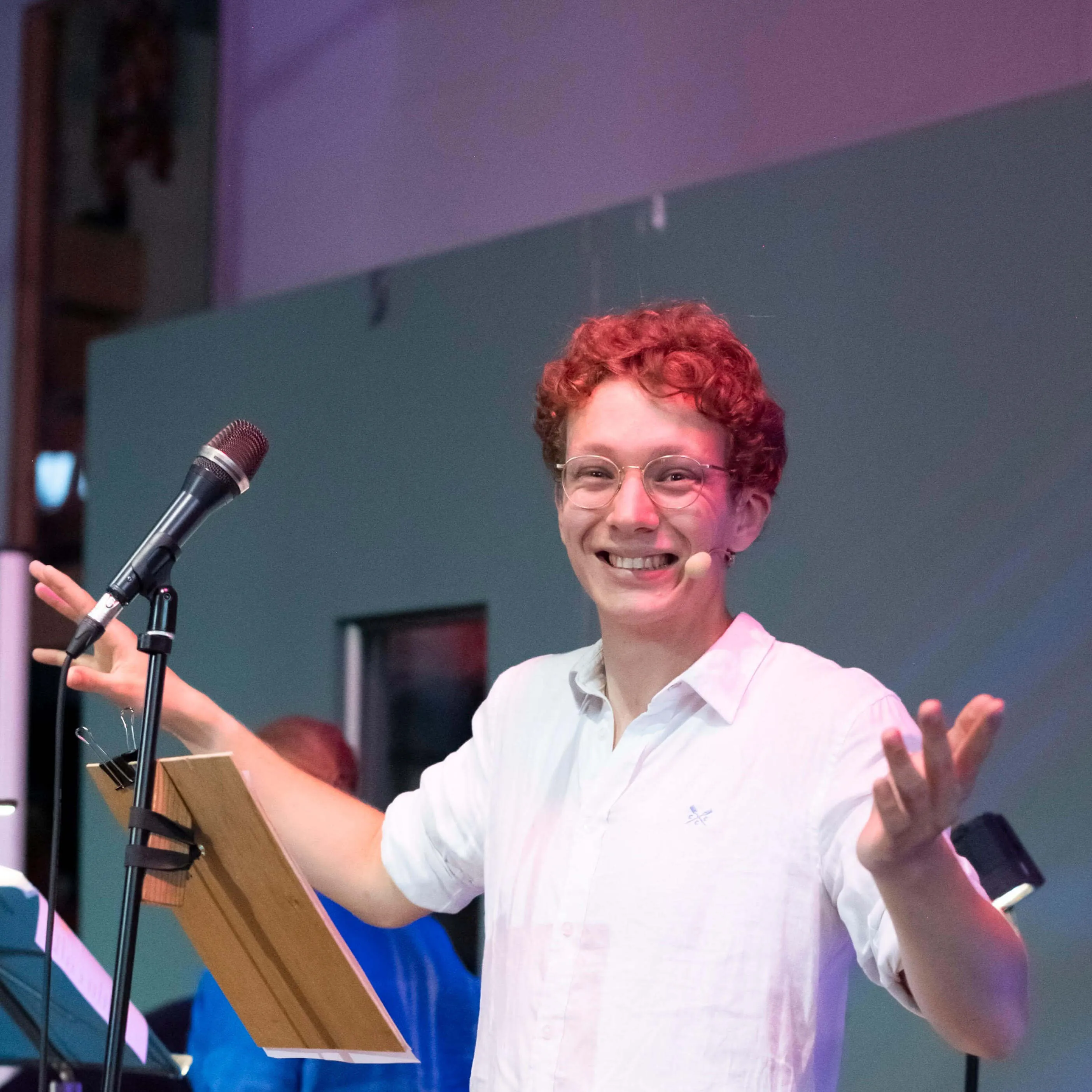 Jack, wearing a white shirt and a headset mic, calling a contra